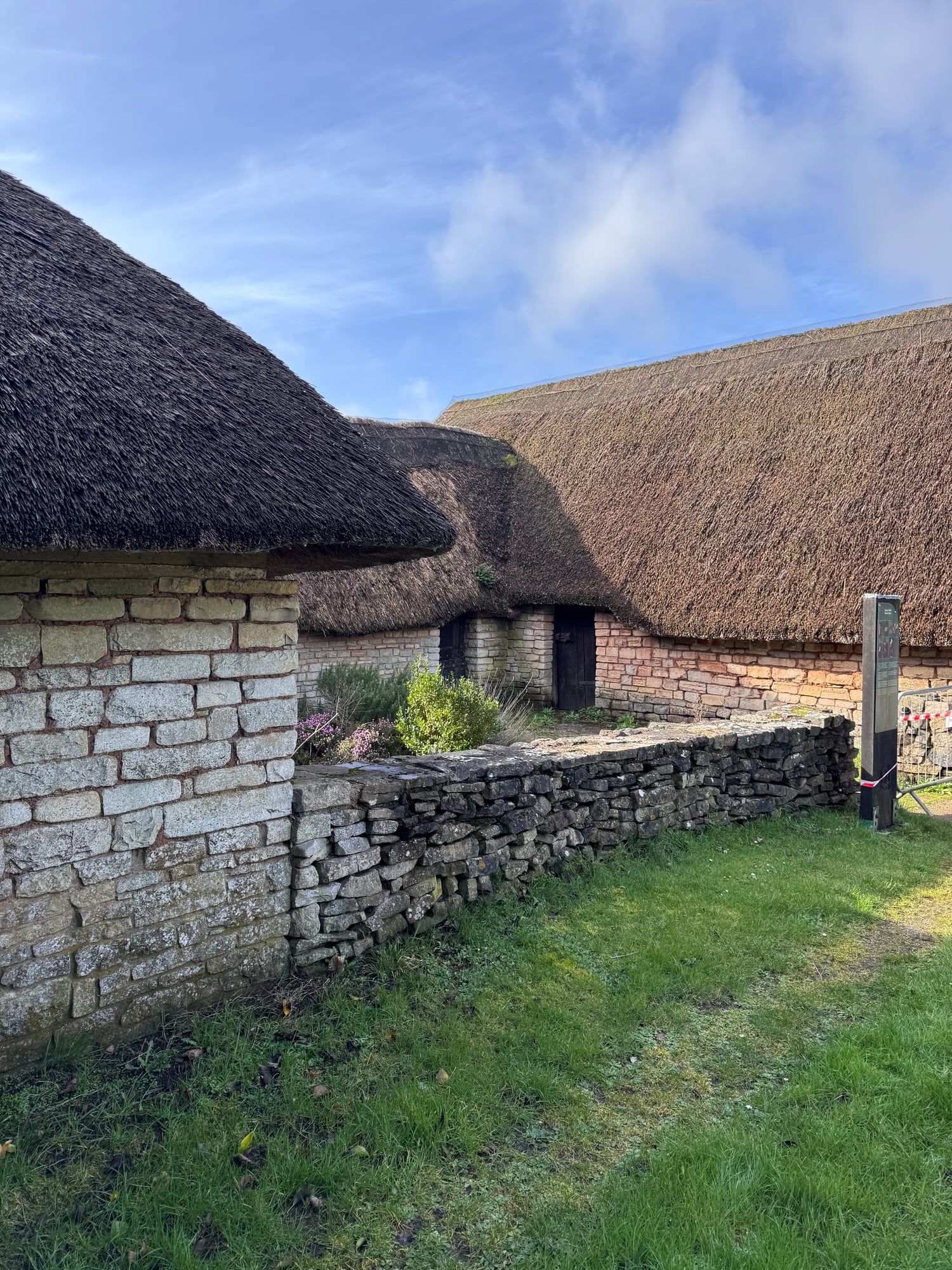 Reconstructed stone houses with thatched roofs at Cosmeston Medieval Village