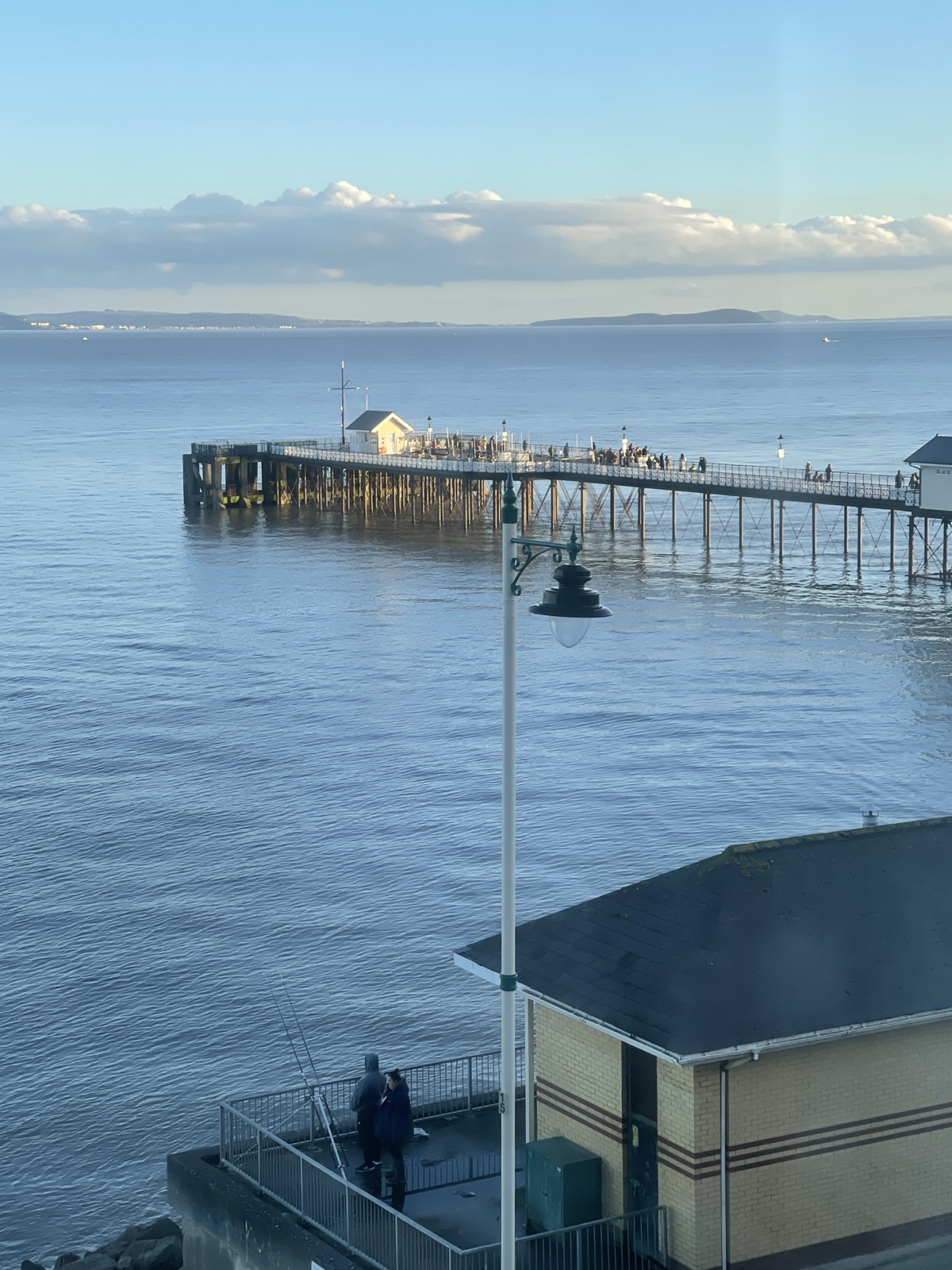 Penarth Pier over calm blue water with the Bristol Channel beyond